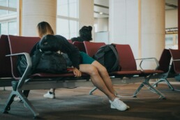 unknown person lying on brown bench indoors